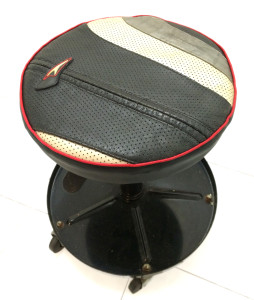 Garage stool covered with racing leathers
