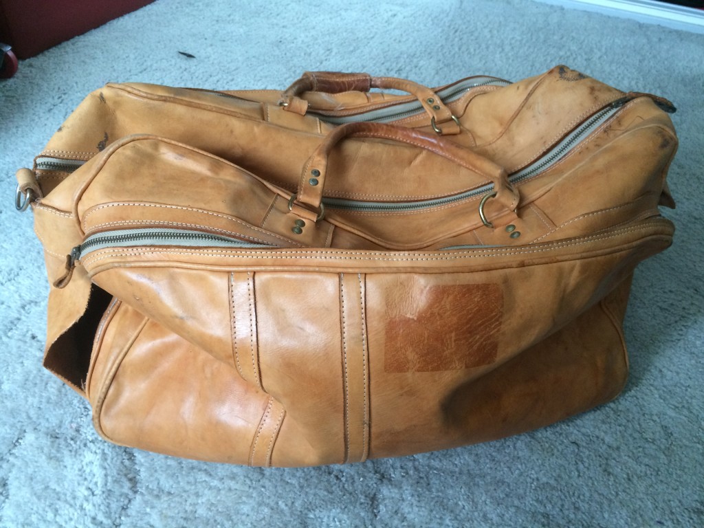Damaged leather luggage.